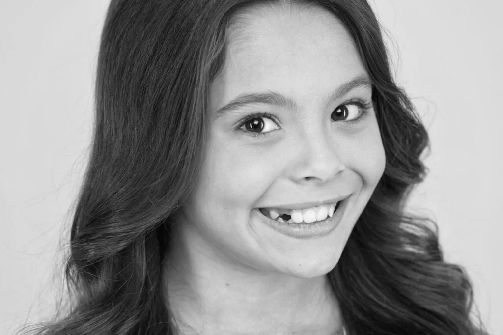 Smiling child with missing front teeth, showcasing a cheerful expression, representing pediatric dental care and healthy oral habits at Nola Pediatric Dentistry in Metairie, LA.